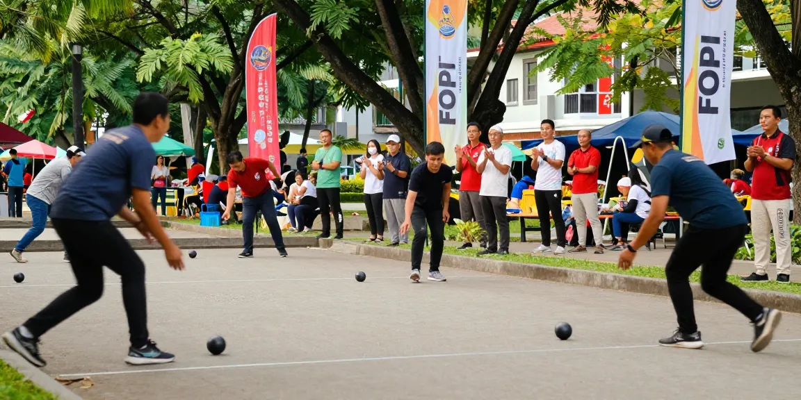 Engaged players at an outdoor petanque tournament representing fopikotamanado.org with spectators, vibrant park setting.